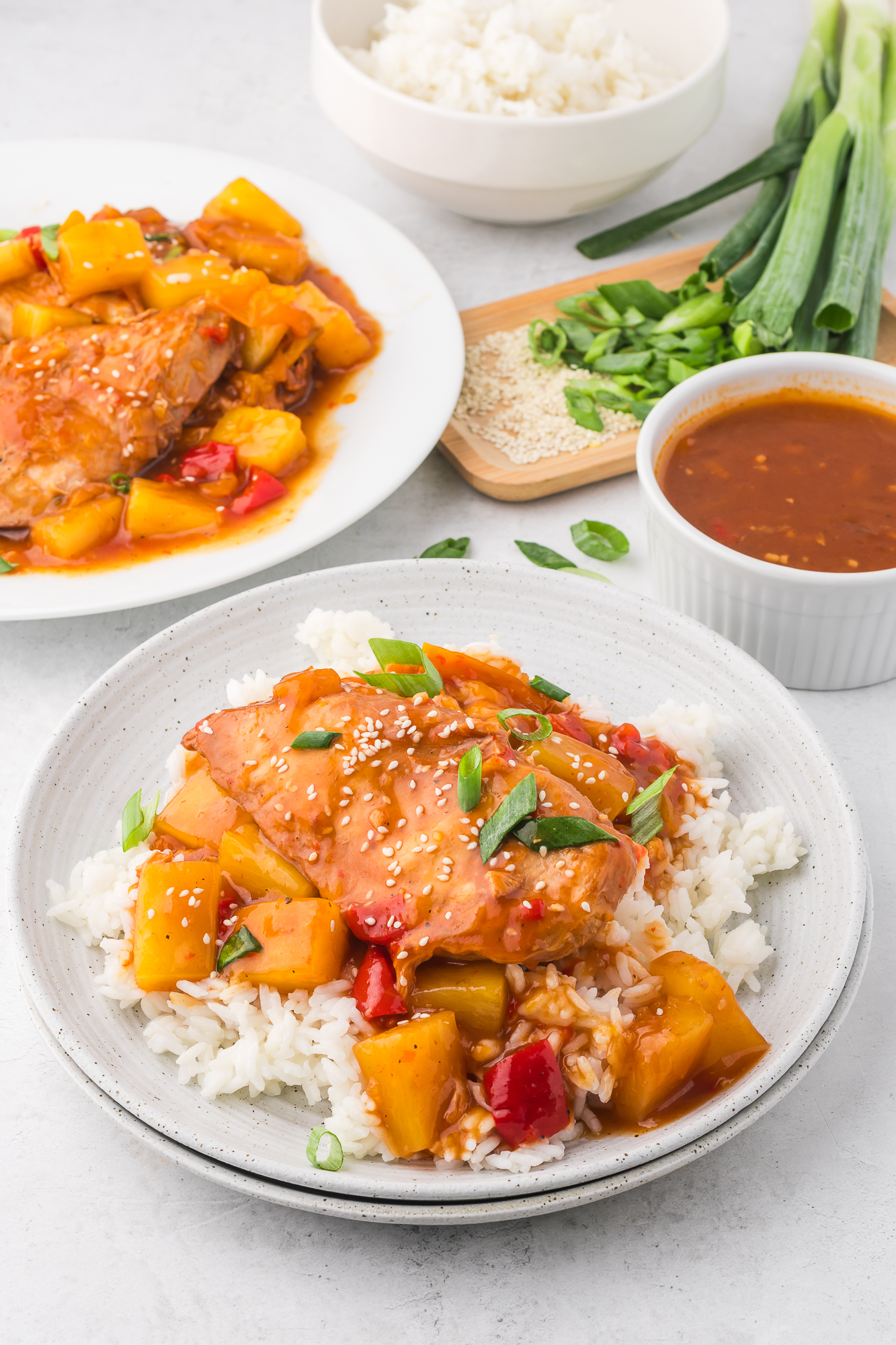 A plate Slow Cooker Hawaiian Chicken on a bed of white rice.