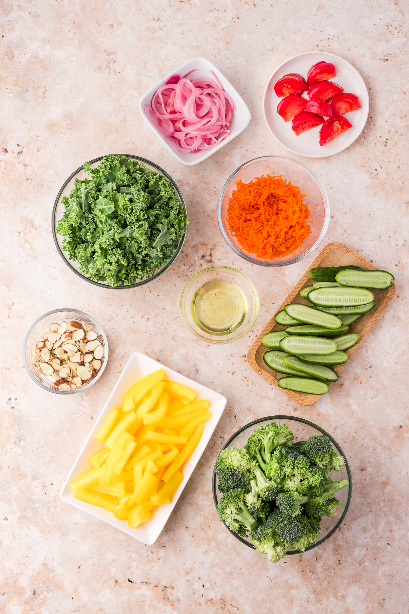 A mis-en-place of ingredients for Kale Broccoli Salad.