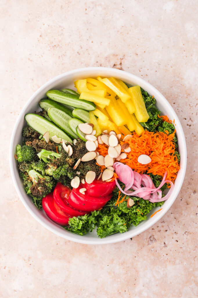 A white bowl of Kale Broccoli Salad.