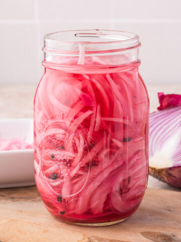 A mason jar of Pickled Red Onions,