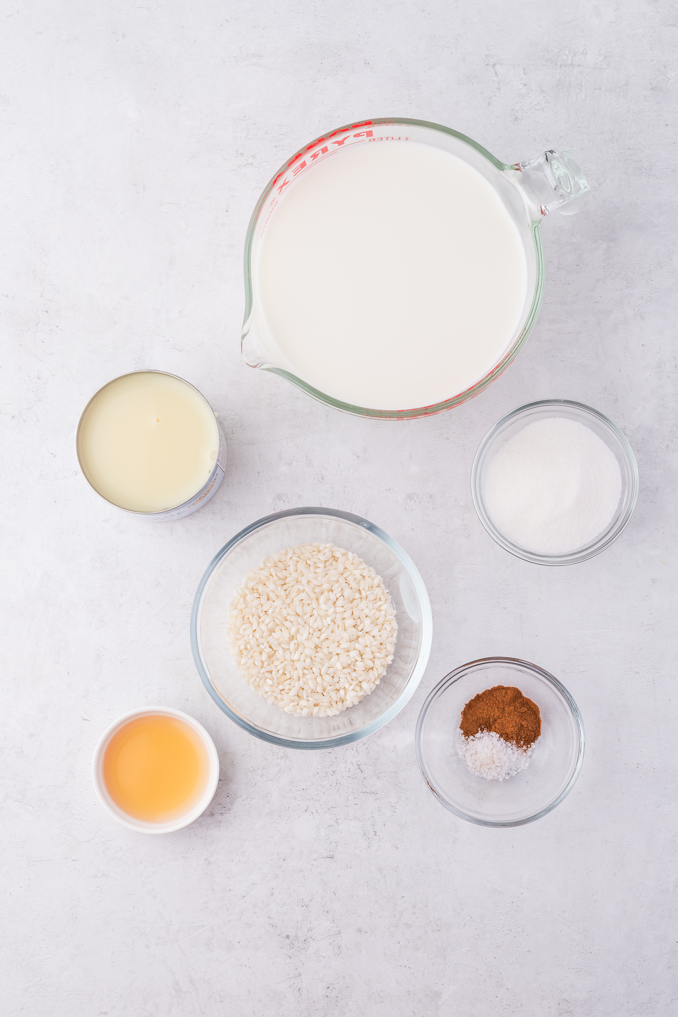 A mis-en-place of the ingredients for Rice Pudding with Condensed Milk.