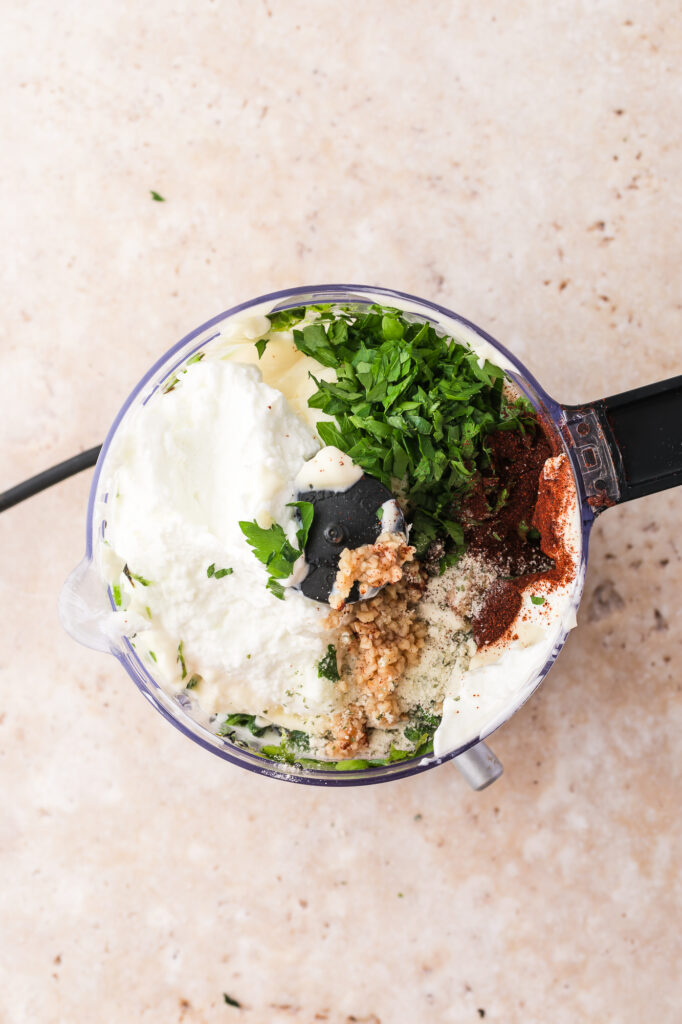 All the ingredients for Smoky Poblano Ranch Dressing in a food processor before blending.