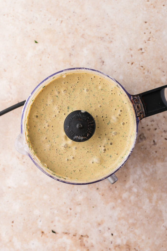 The blended Smoky Poblano Ranch Dressing in a food processor.