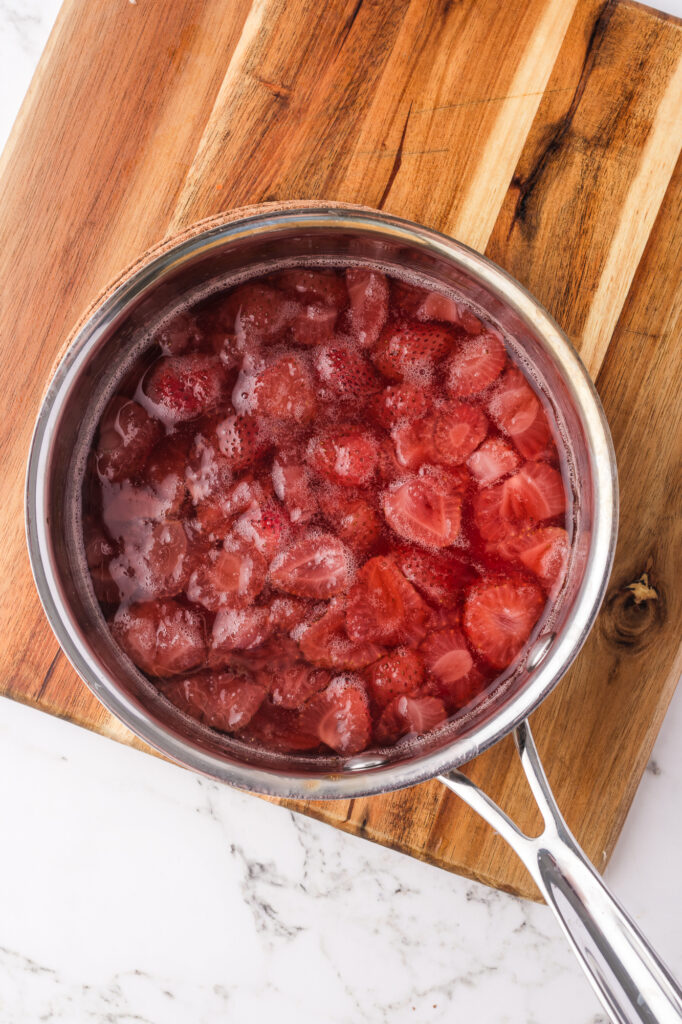 A saucepan of cooked strawberries.