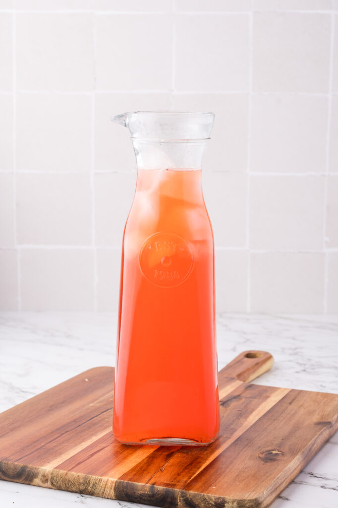 A carafe of Sparkling Strawberry Lemonade.