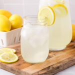 A mason jar of State Fair Lemonade with a lemon slice on the rim of the jar.