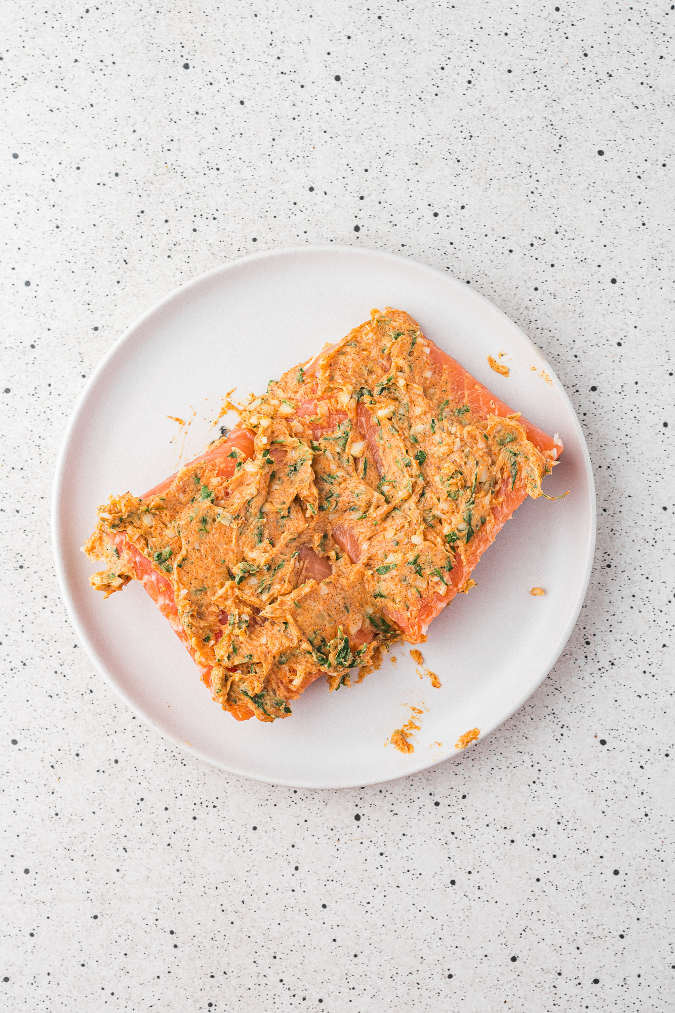 Two salmon filets coated in the garlic butter.