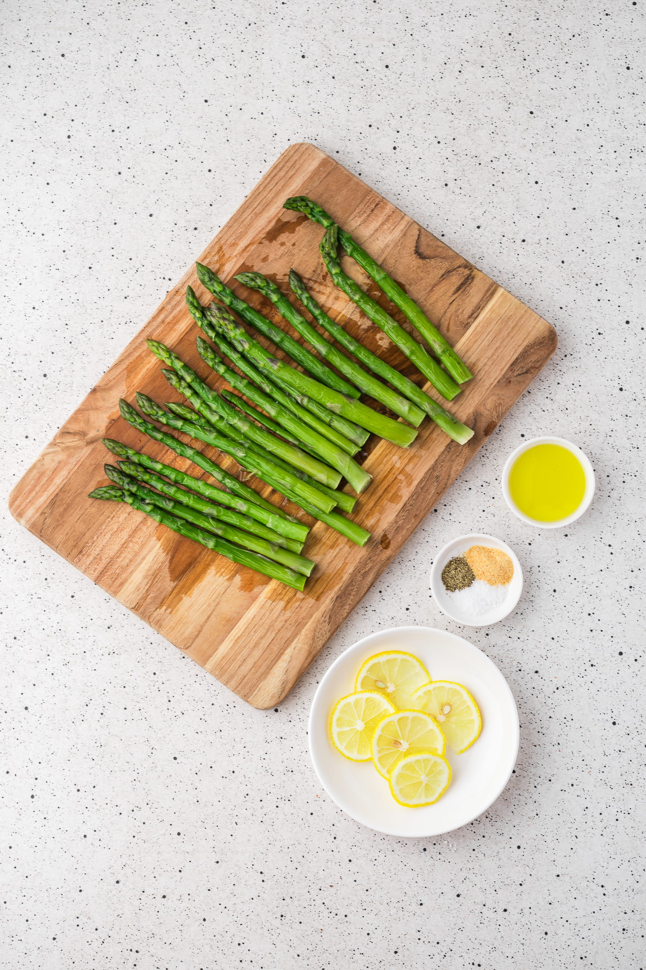 A mis-en-place of ingredients for Air Fryer Lemon Asparagus.