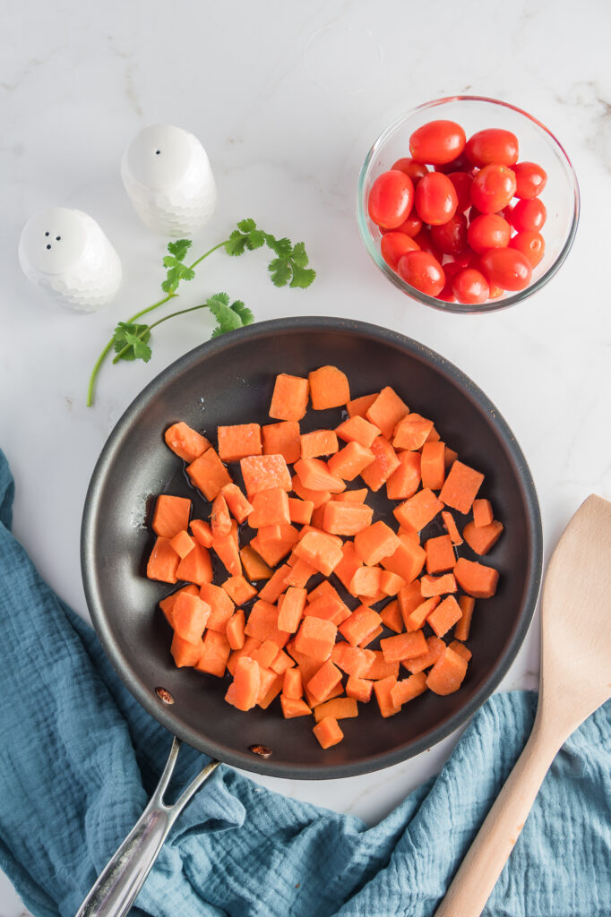 A pan of raw diced sweet potatoes for Sweet Potato Breakfast Burritos.