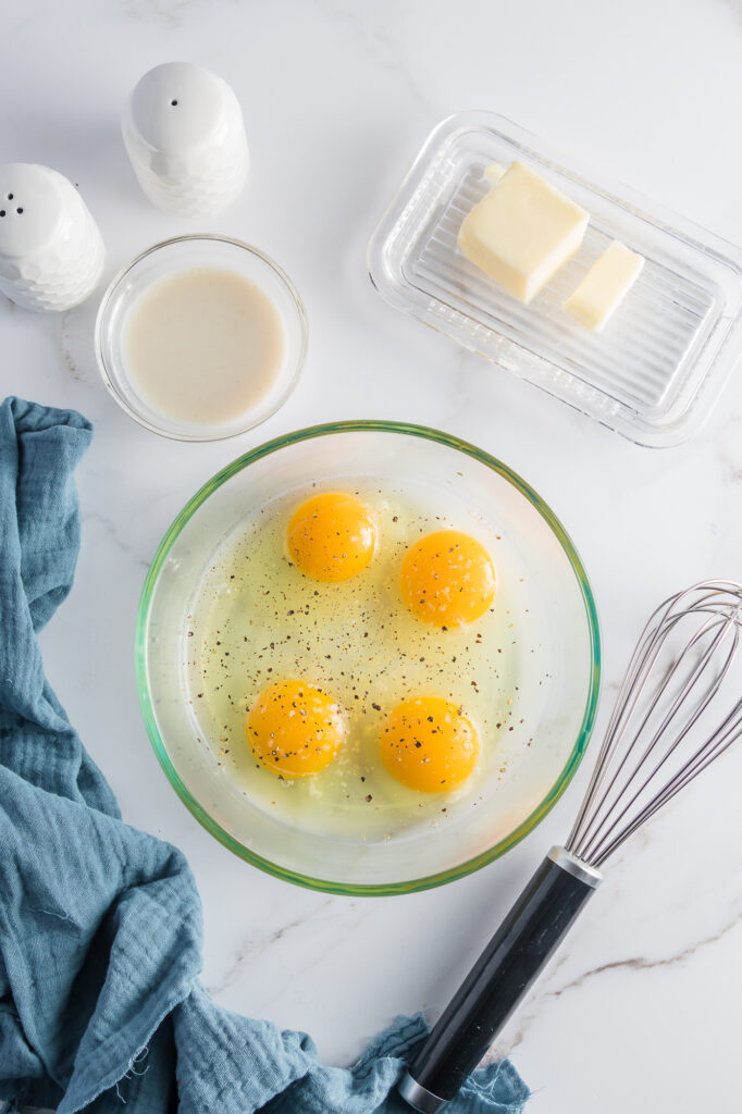 A bowl of raw eggs, yolk in tact.