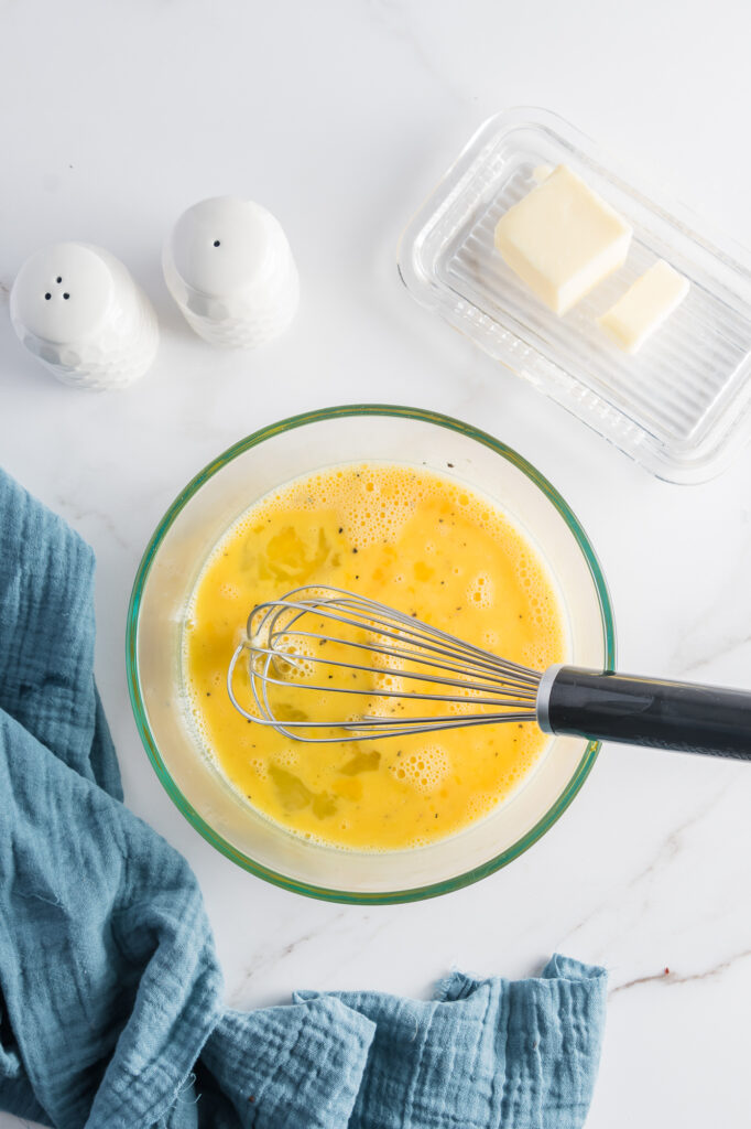 A bowl of whisked raw eggs.