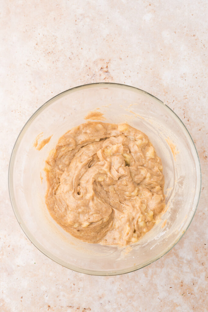 A glass bowl of the wet and dry ingredients mixed together.