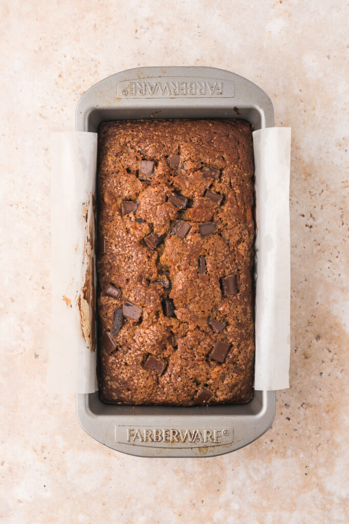 A baked Chocolate Chunk Banana Bread in a loaf pan.