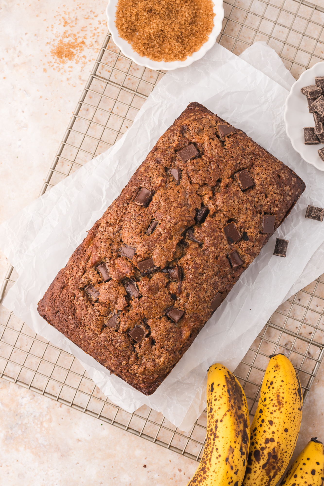 A baked Chocolate Chunk Banana Bread on a cooling rack.