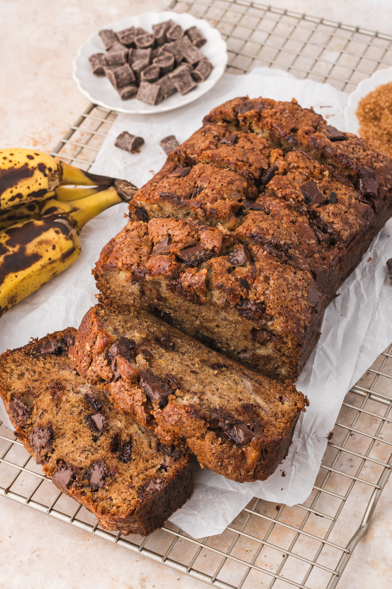 A sliced Chocolate Chunk Banana Bread on a cooling rack.