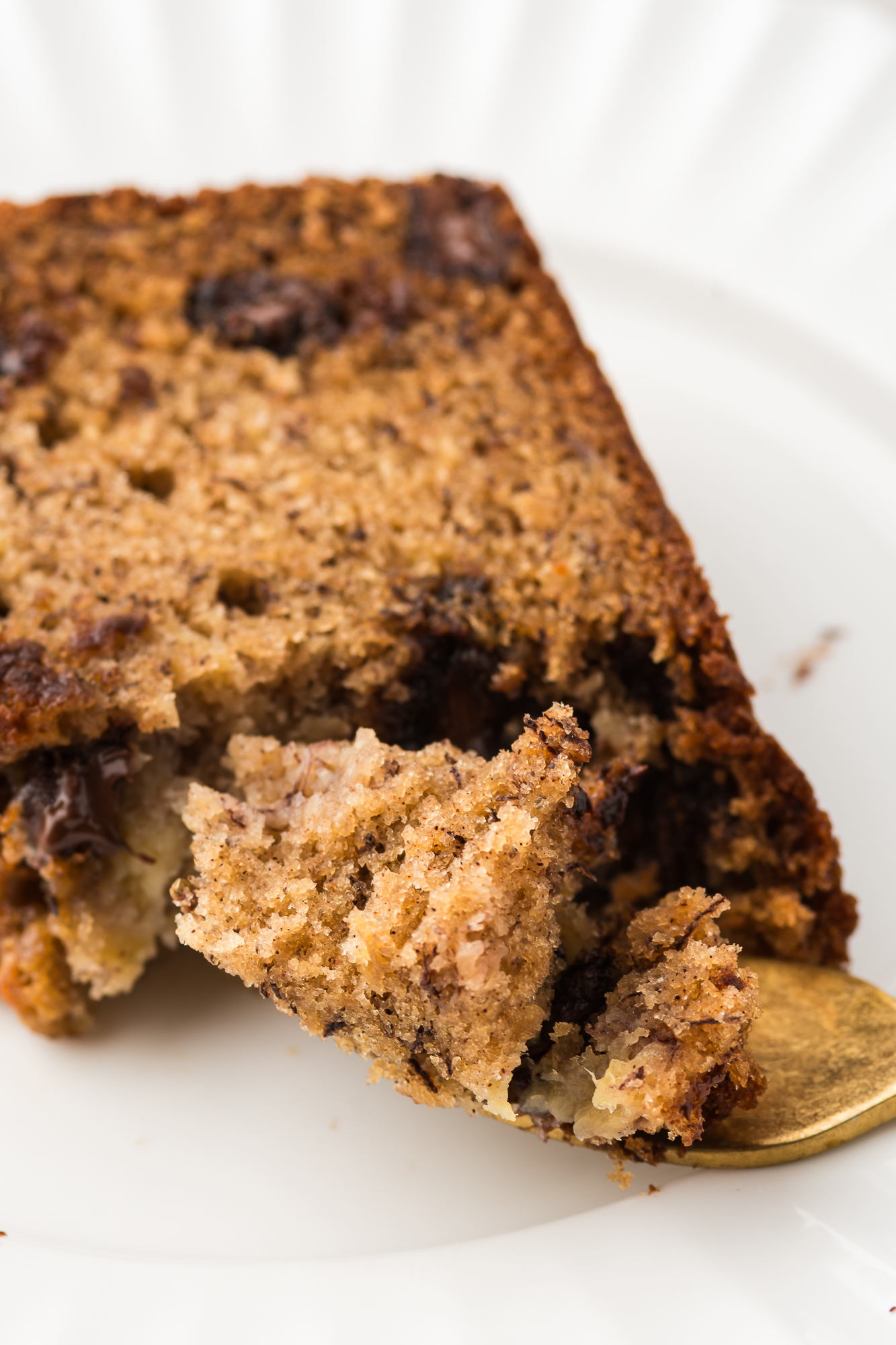 A close-up of a slice Chocolate Chunk Banana Bread.