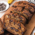 A sliced loaf of Chocolate Chunk Banana Bread.