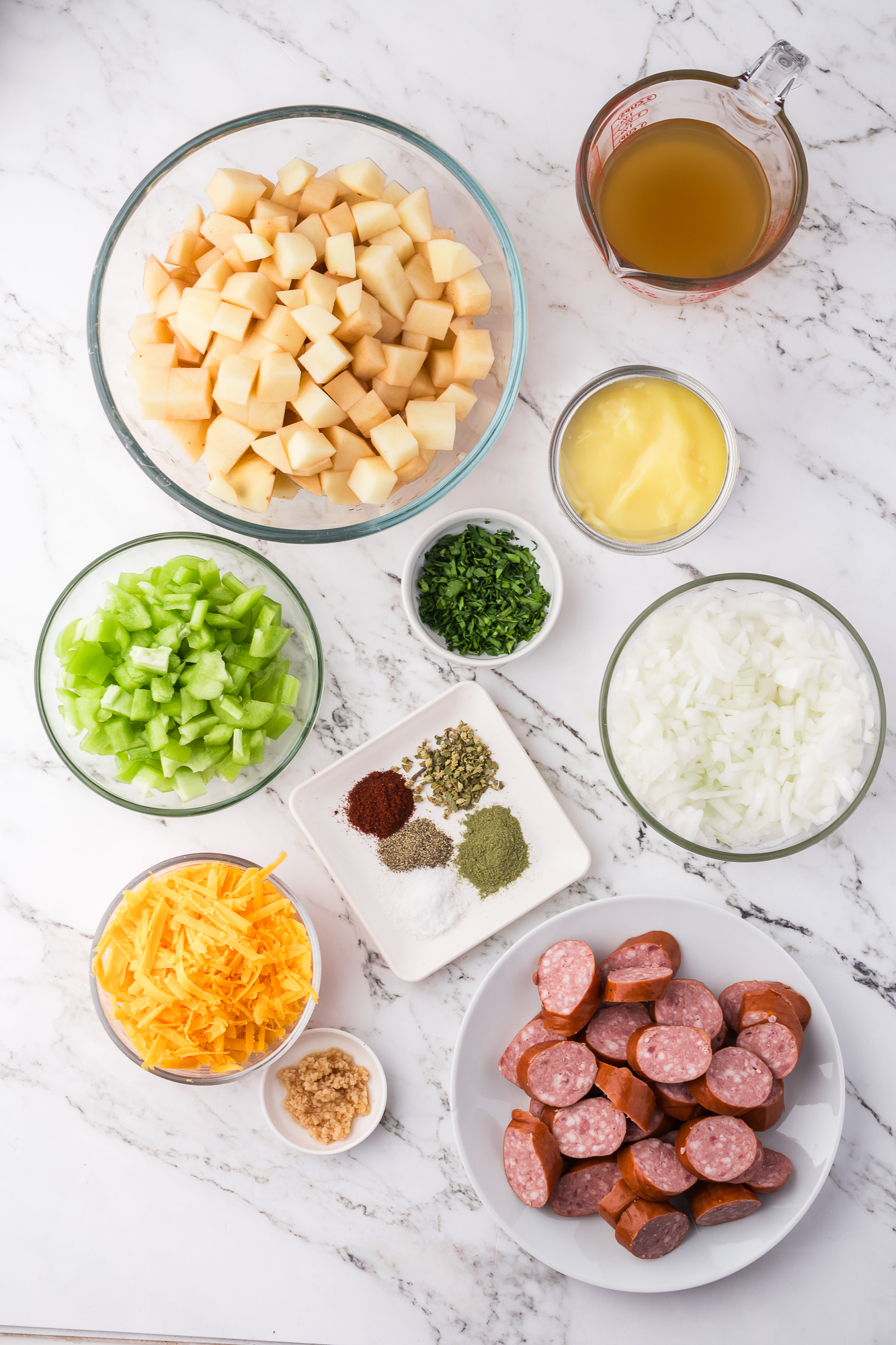 A mis-en-place of the ingredients for Slow Cooker Sausage Potato Casserole.