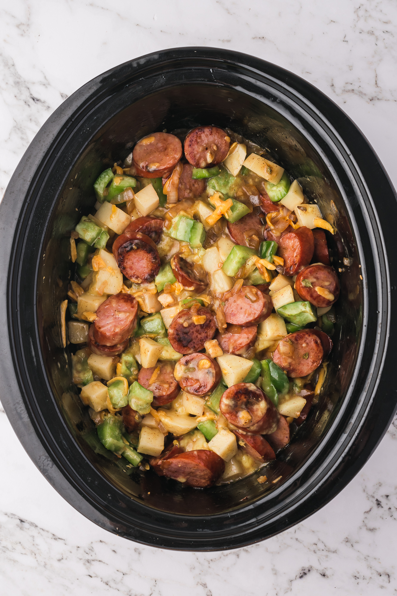 The cooked Slow Cooker Sausage Potato Casserole in the slow cooker.