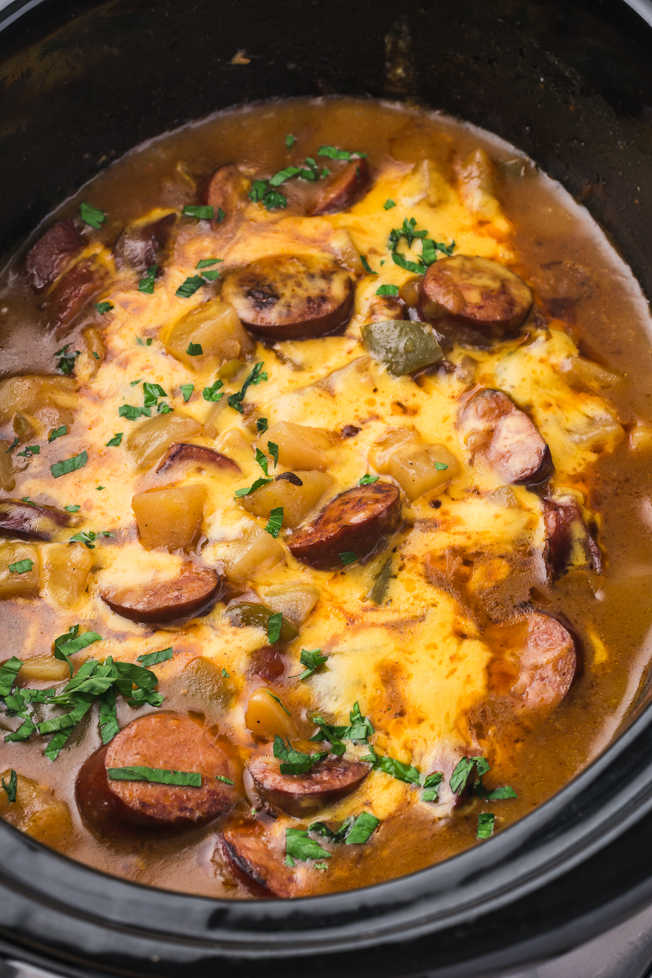 A close up of Slow Cooker Sausage Potato Casserole in the slow cooker.