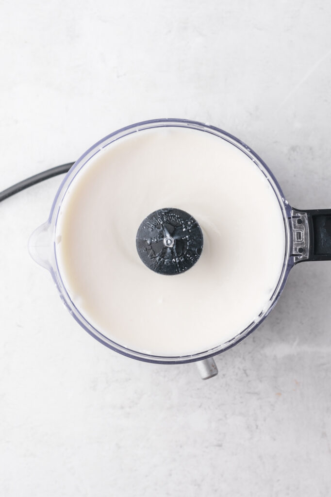 Cottage cheese, vanilla extract, and honey in a food processor after blending.