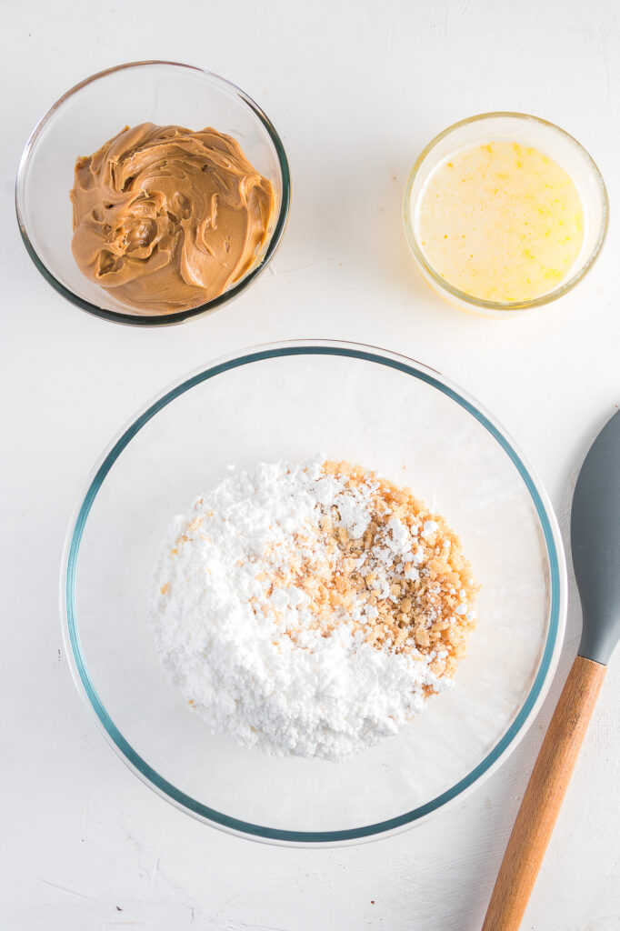 A mixing bowl of dry ingredients for Crispy Peanut Butter Chocolate Bars.