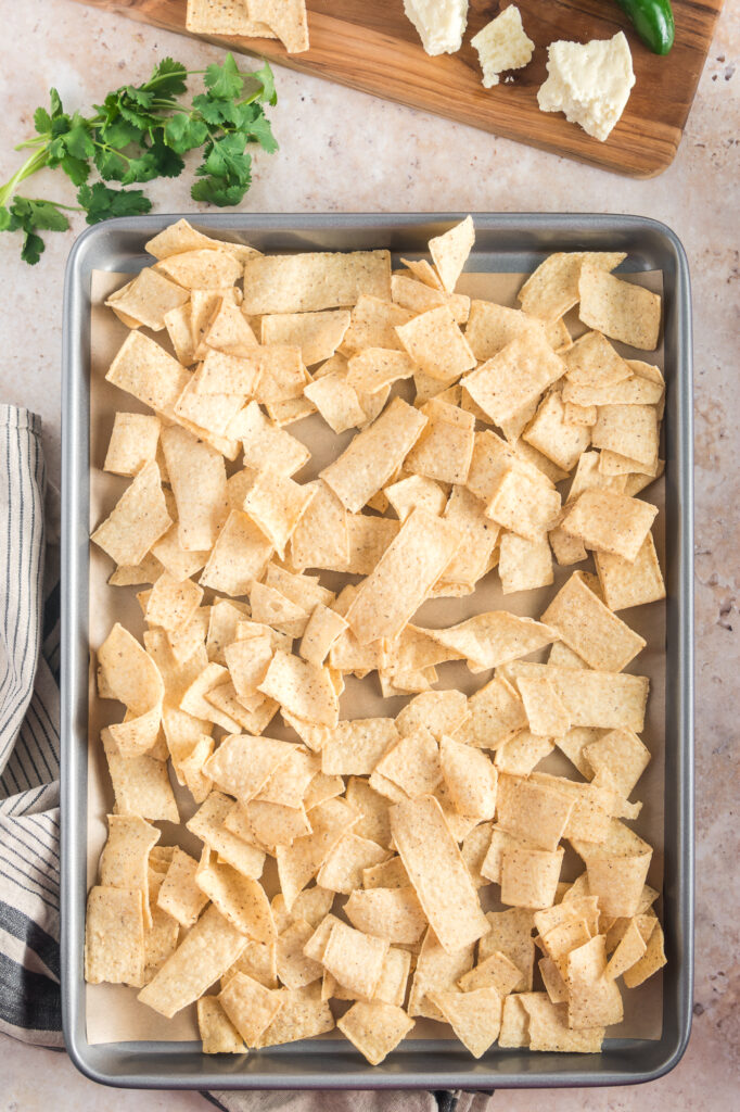 A baking sheet of nacho strips for Sheet Pan Nachos.