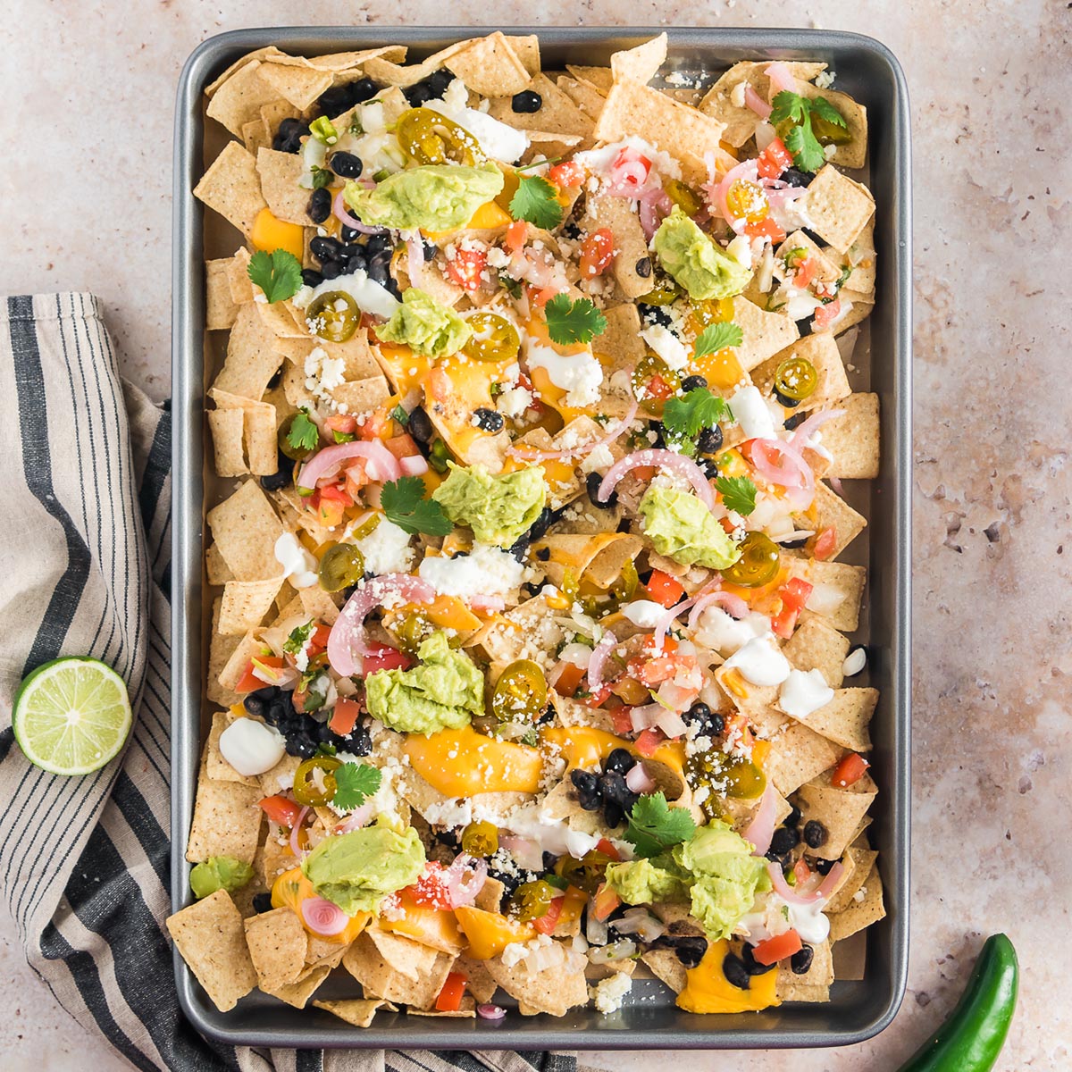 A baking sheet of Sheet Pan Nachos.