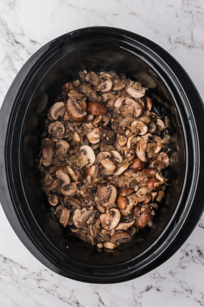 A mushroom mixture in the slow cooker for Slow Cooker Mushroom Risotto.