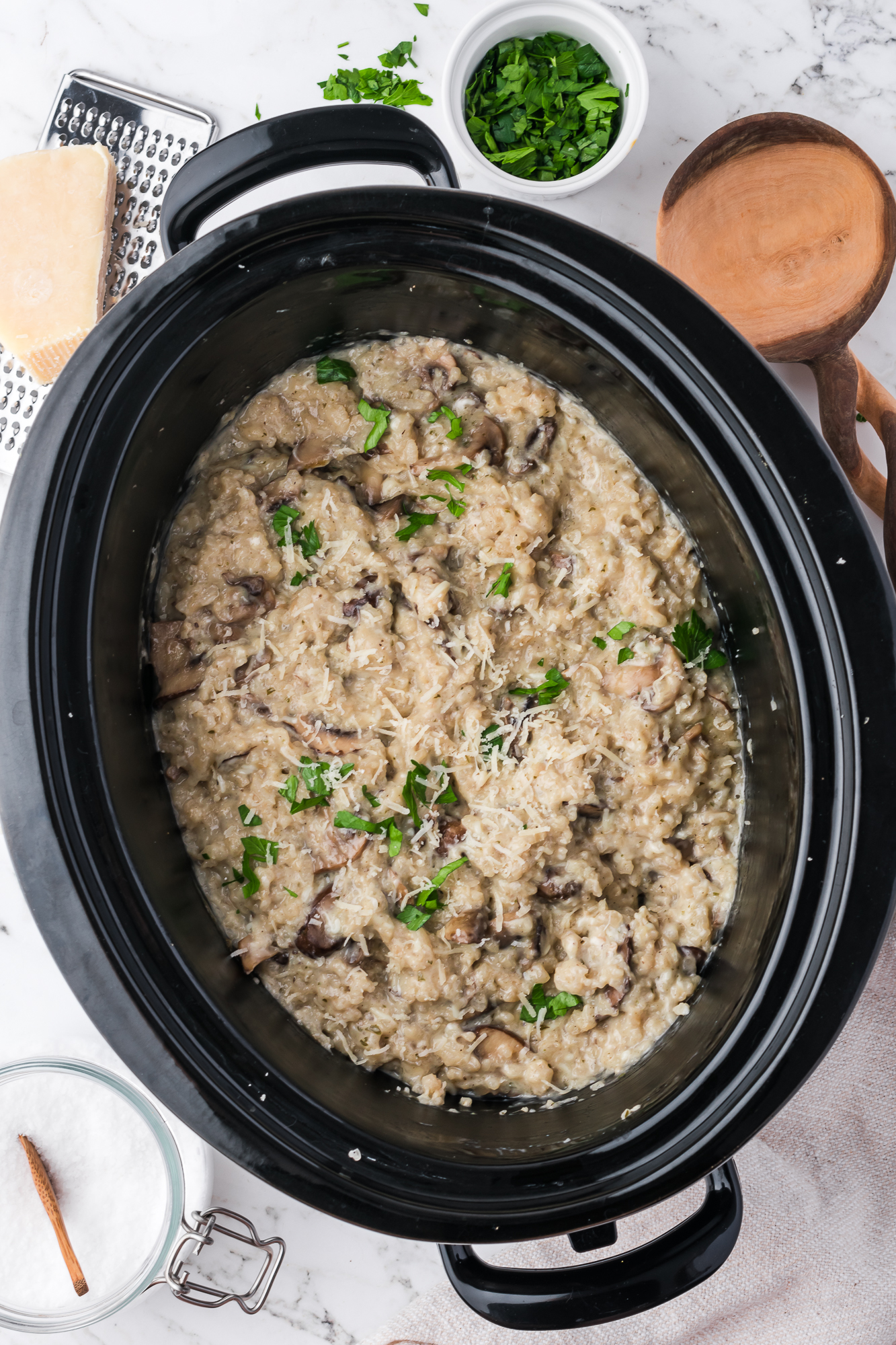 The Slow Cooker Mushroom Risotto in the slow cooker garnished with fresh parsley.