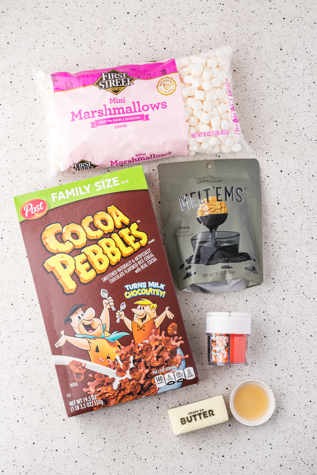 A mis-en-place of ingredients for Spooky Cocoa Pebbles Treats.