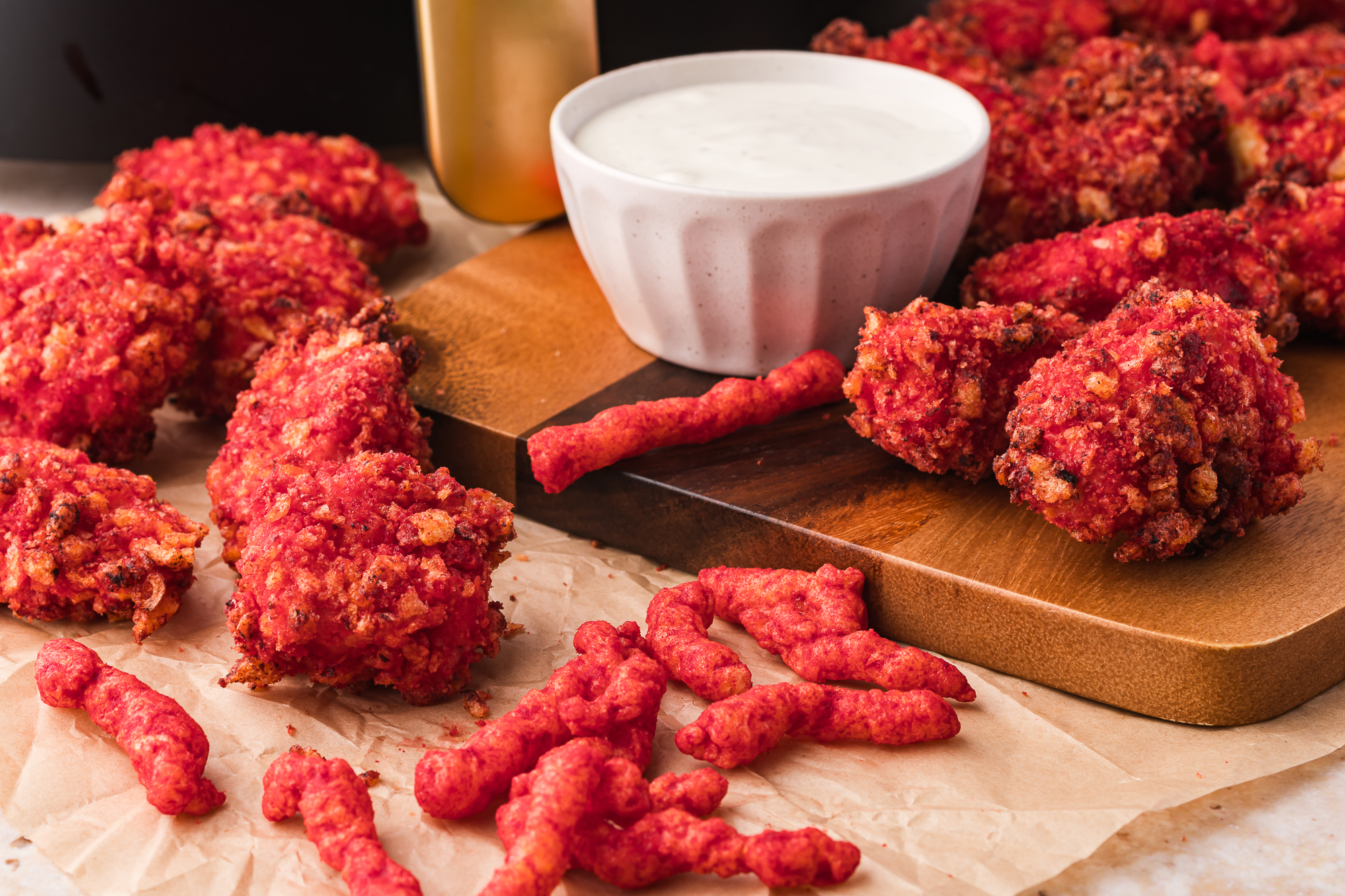 A close up of a tray of Air Fryer Flamin' Hot Cheetos Nuggets and a bowl of ranch dressing.