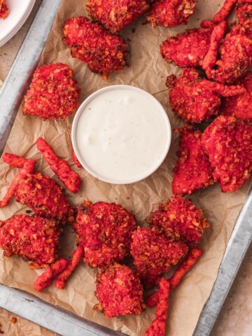 A tray of Air Fryer Flamin' Hot Cheetos Nuggets with a small bowl of ranch dressing.