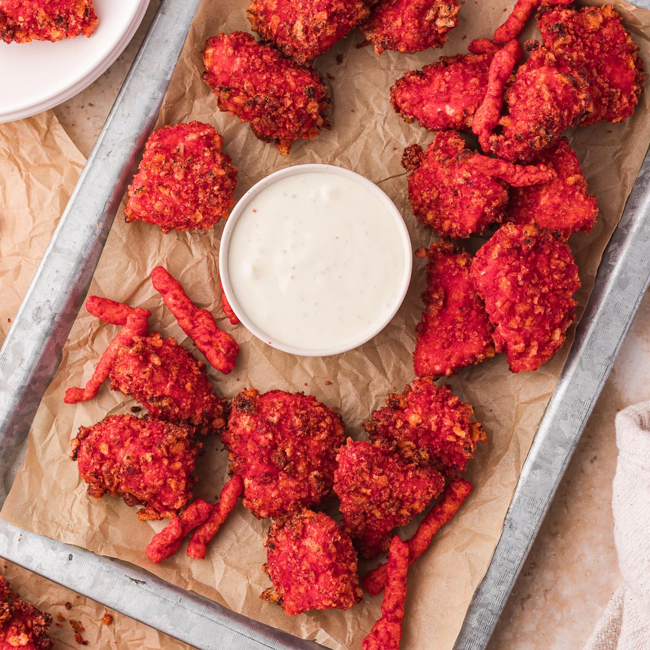 A tray of Air Fryer Flamin' Hot Cheetos Nuggets with a small bowl of ranch dressing.