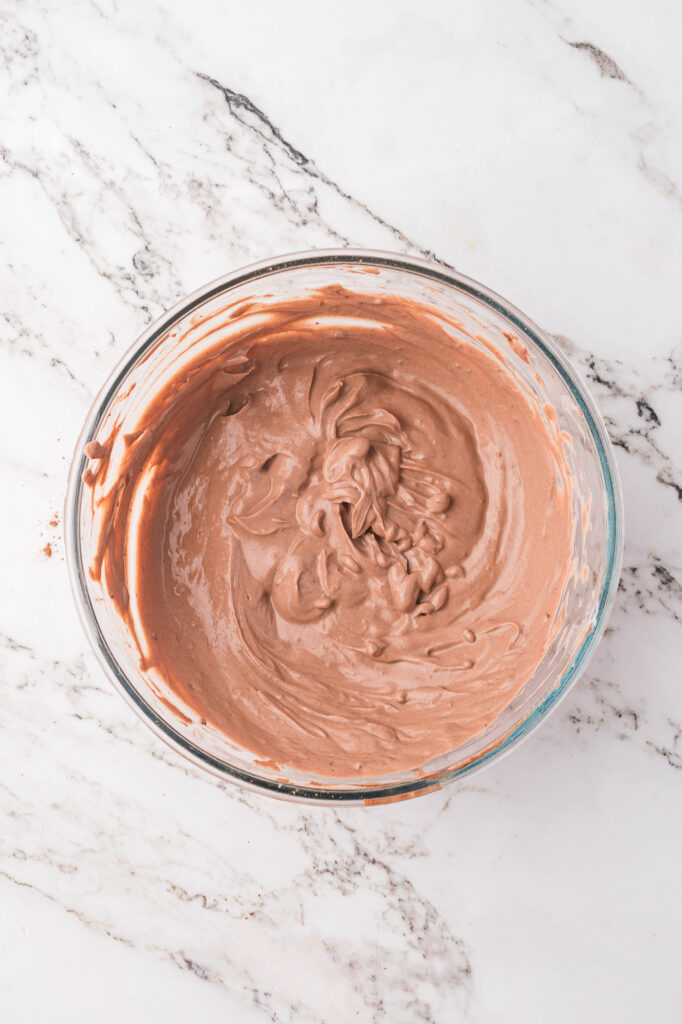 A glass bowl of mixed Chocolate Protein Pudding