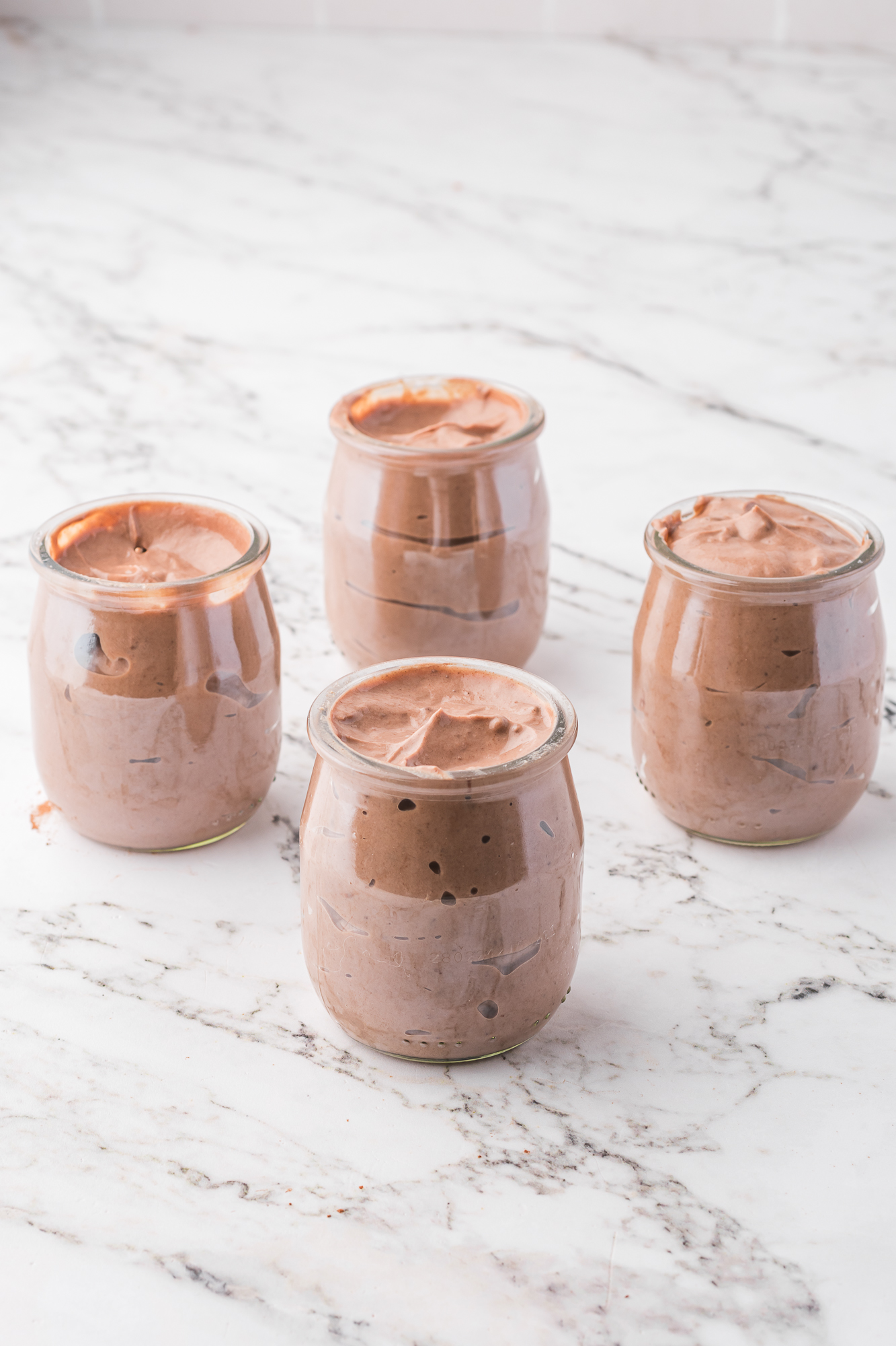 The Chocolate Protein Pudding mixture separated into four glasses.