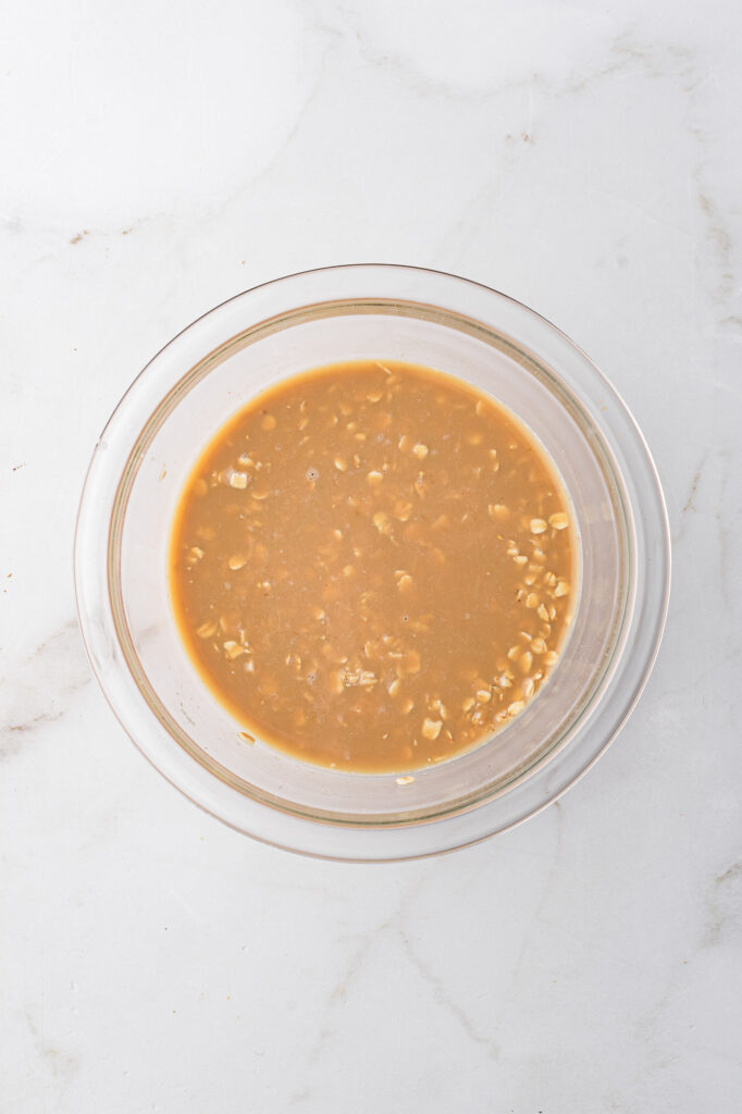 A glass bowl with the overnight oat mixture.