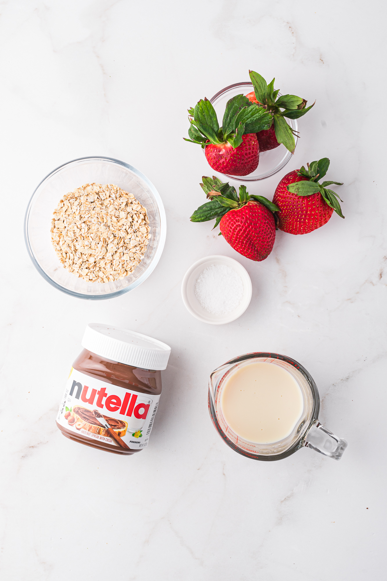 A mis-en-place of ingredients for Nutella Overnight Oats.