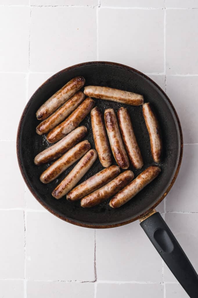 A pan of browned sausage in a pan