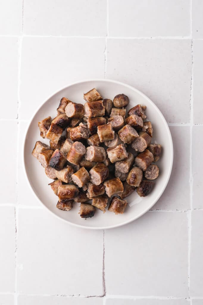 A plate of sliced, browned sausges.