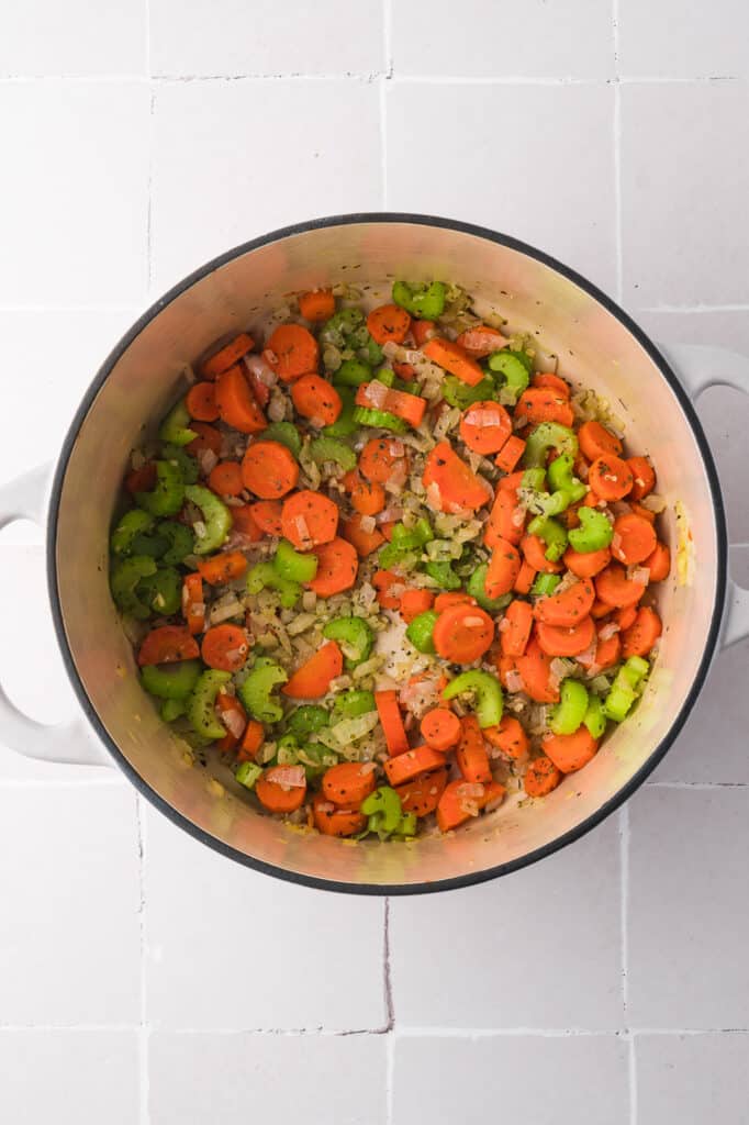 A pot of cooked carrots, celery, and onion