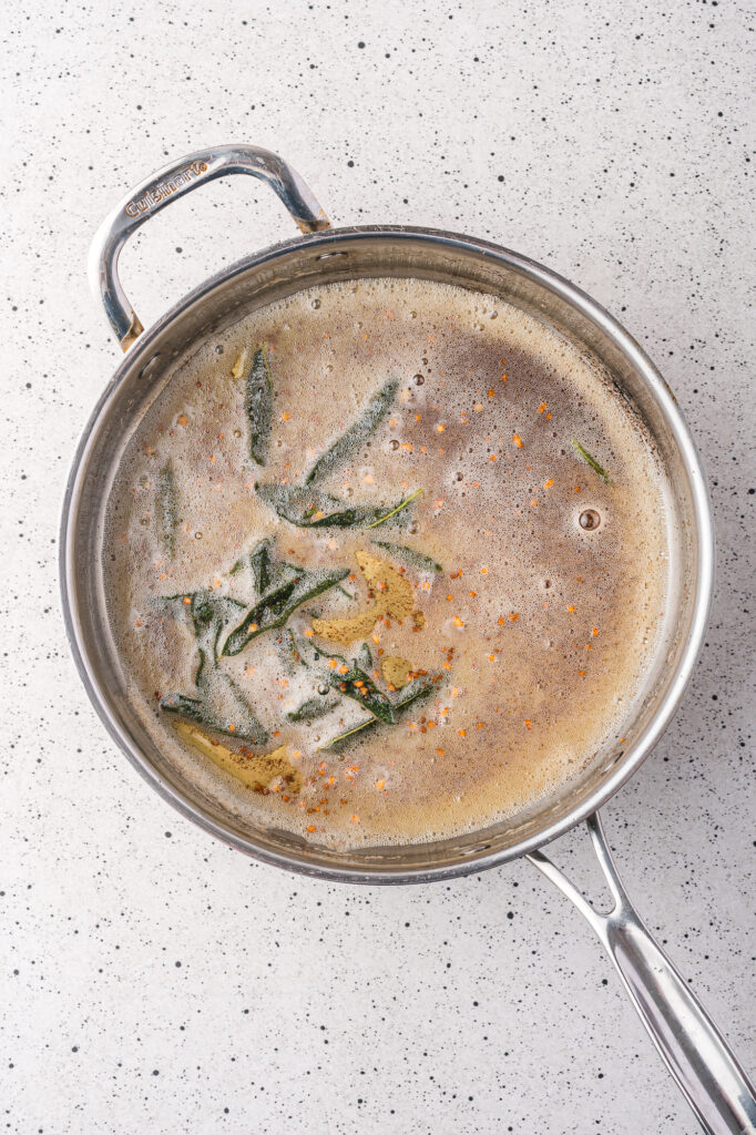 Browned butter with sage leaves in a pan.