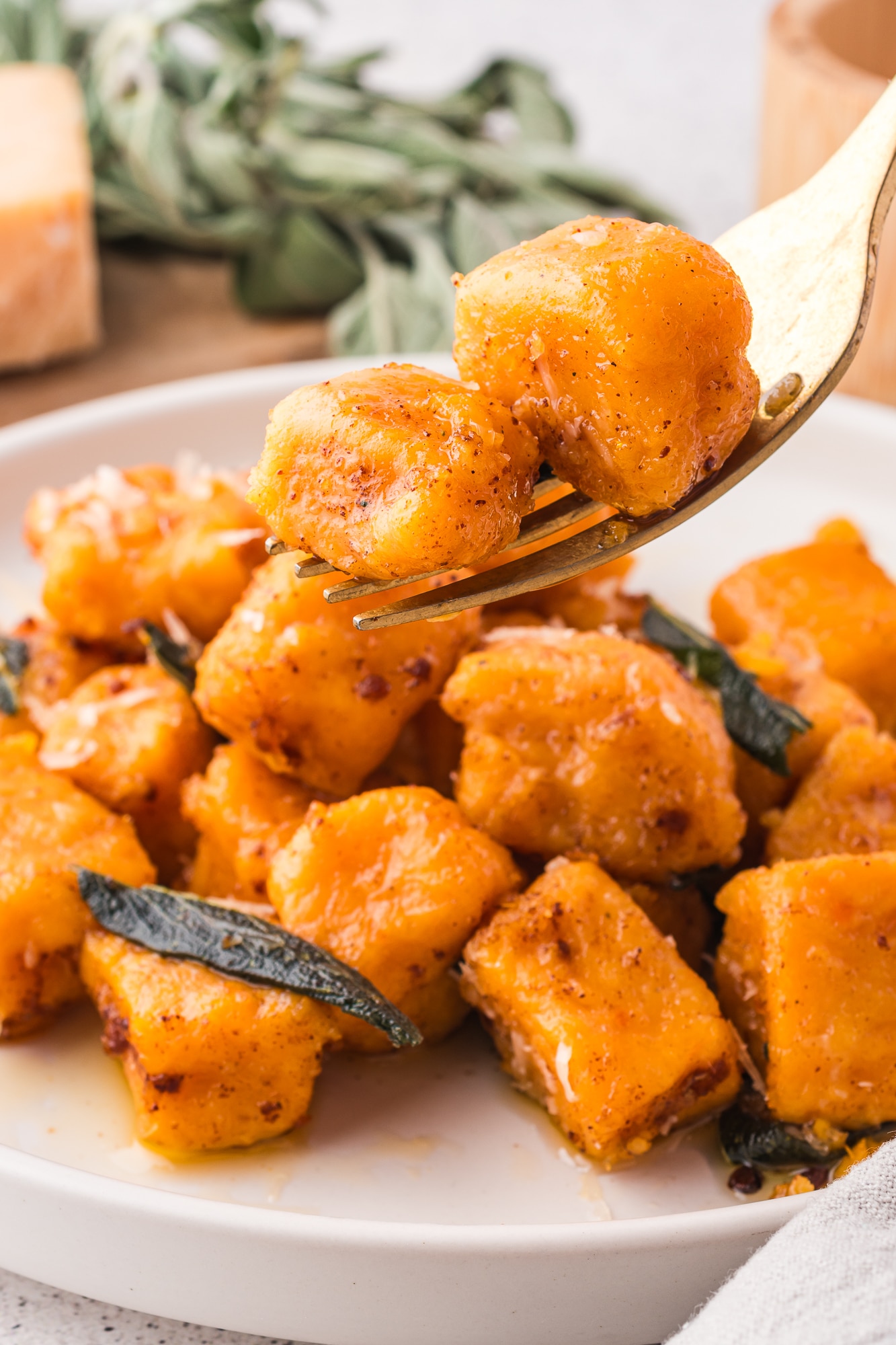 A close up of a forkful of Sweet Potato Gnocchi with Sage Brown Butter Sauce.