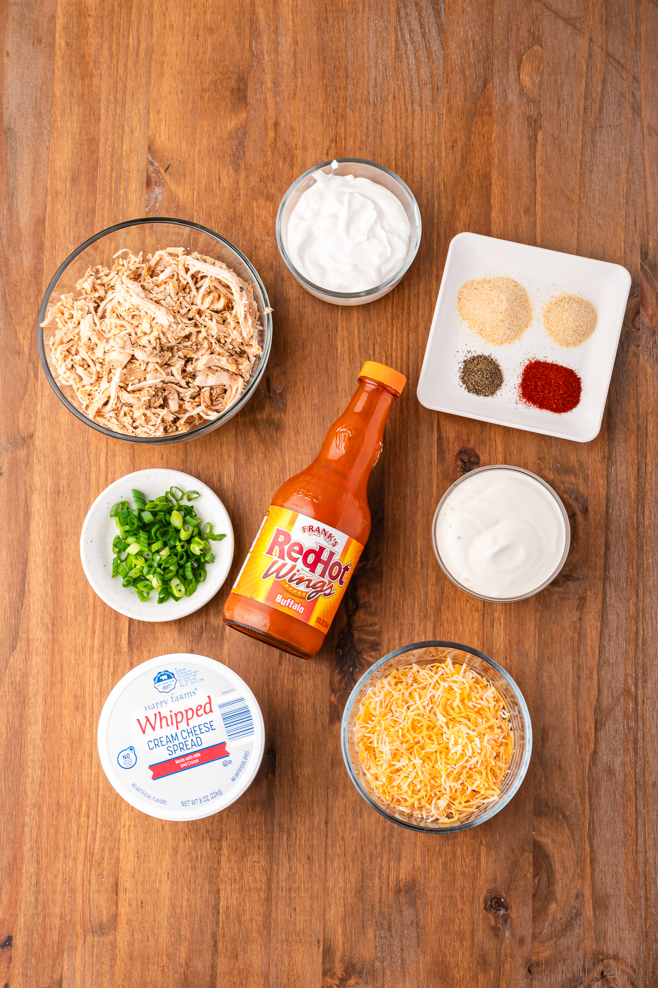 A mis-en-place of ingredients for Buffalo Chicken Dip with Frank's Buffalo Sauce.
