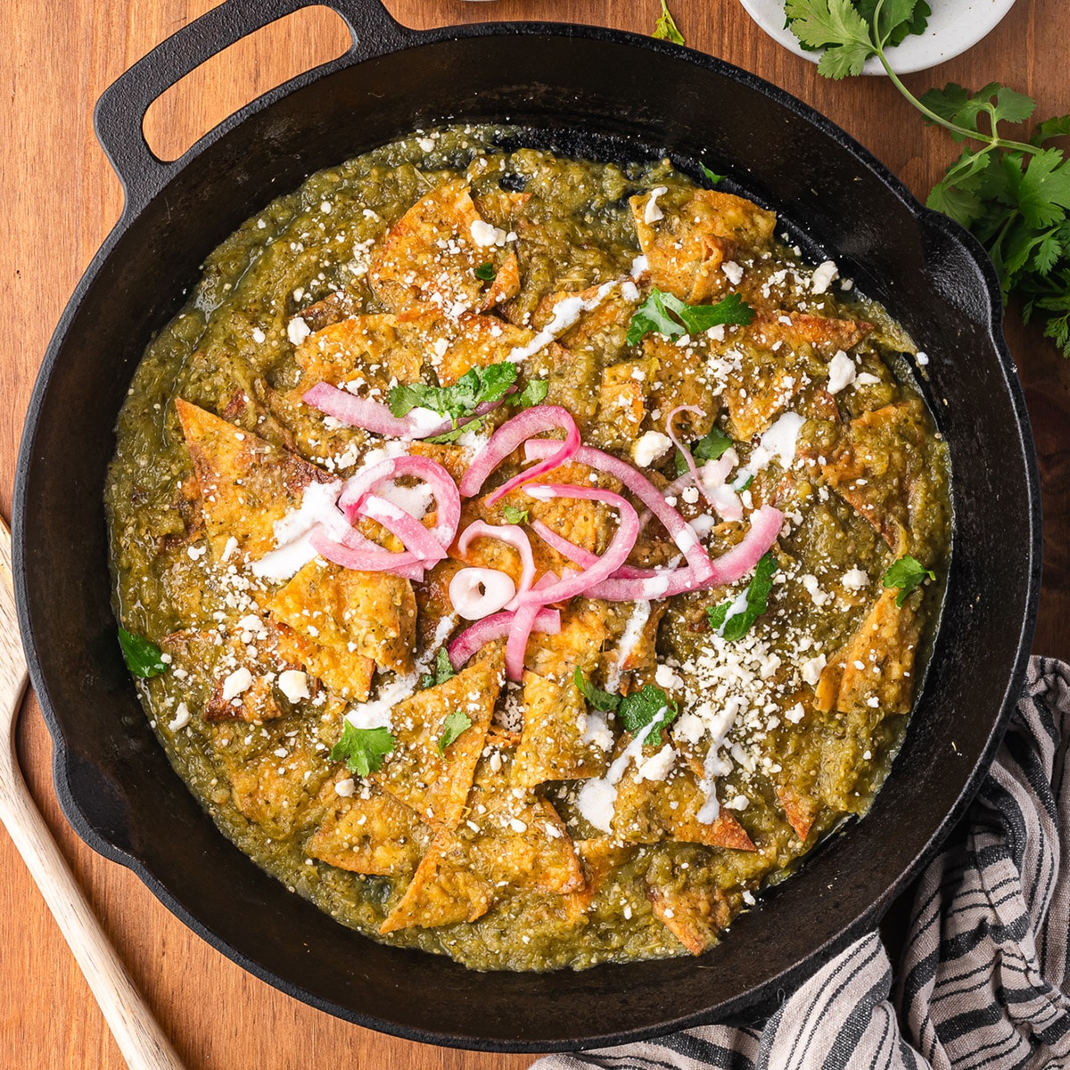 Completed Chilaquiles Verdes in a large black skillet