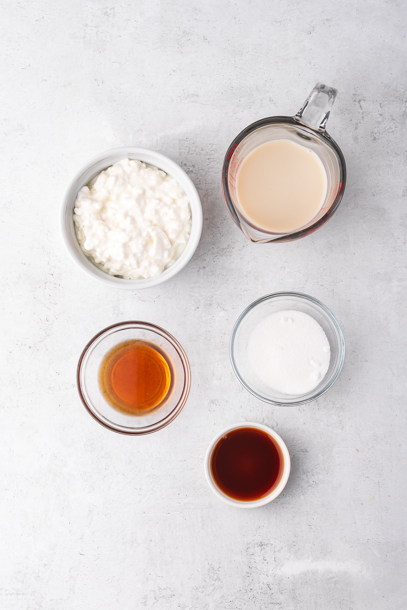 A mis-en-place of ingredients for Ninja Creami Vanilla Cottage Cheese Ice Cream