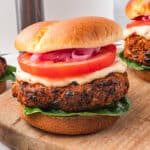 An Air Fryer Sweet Potato and Black Bean Burger with Sun-dried Tomato Aioli on a hamburger bun