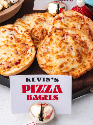 Kevin's Pizza Bagels on a board with a name card in front of them