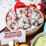A bowl of Reindeer Chow with a red plastic scoop in it