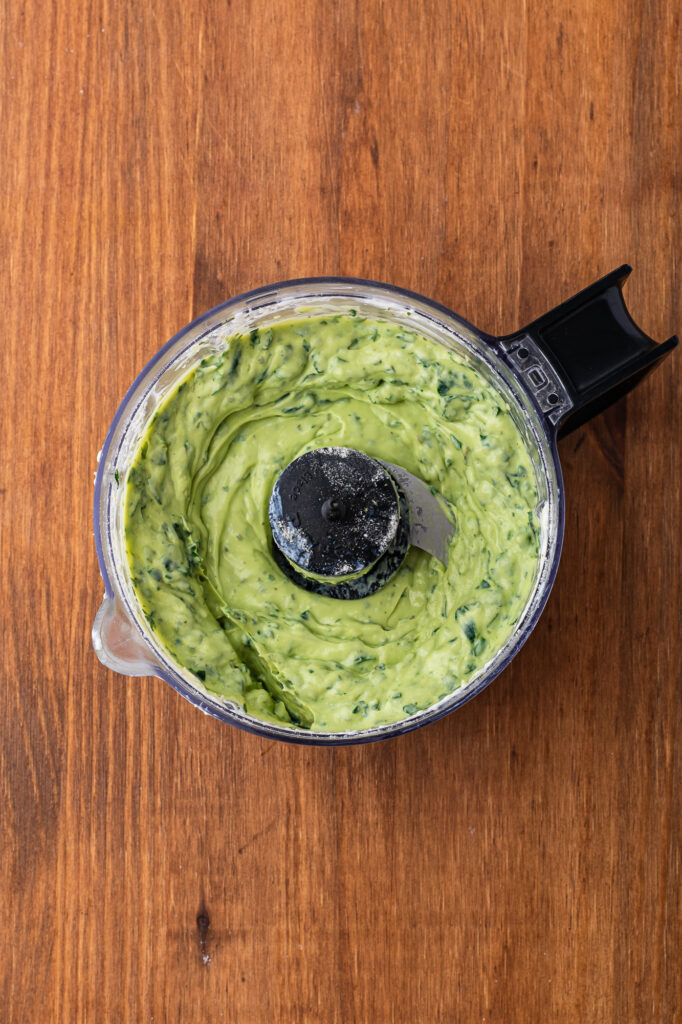 A food processor container with all the ingredients for Sally's Nightshade Dip after mixing